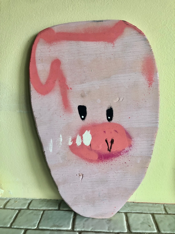 Painted in 2010, this Anthony Lister artwork on plywood is a pig in various pinks with black eyes.